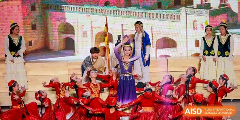 A group of students from Rugao International Academy BFSU in traditional costumes performing on a stage.