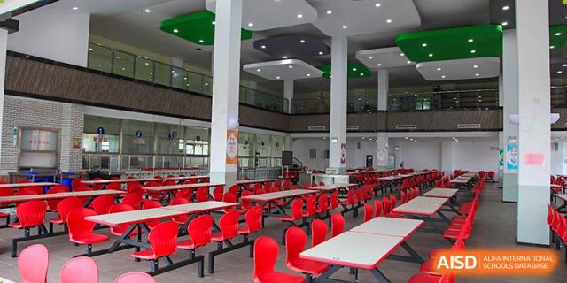 The modern school canteen with red chairs at Rugao International Academy BFSU.