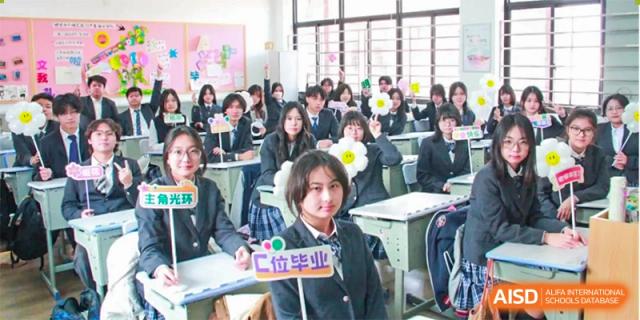 A classroom of female students holding signs and posing for a picture, with one student holding a sign that says "创未来" (Create the Future) at Shanghai Wenlai International School.
