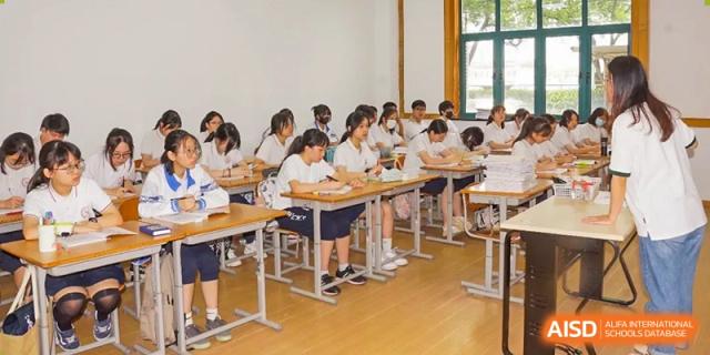 A classroom full of students sitting at individual desks and taking a test or working on an assignment at Shanghai Wenlai International School.