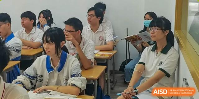 Students sitting at desks and listening attentively during a lesson in a classroom at Shanghai Wenlai International School.
