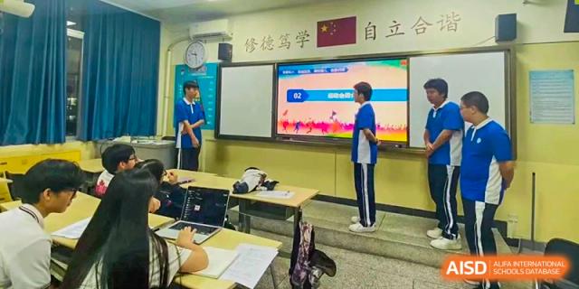 Two students at Shenzhen (Nanshan) Concord College of Sino-Canada using a large screen to play an educational game in a classroom.