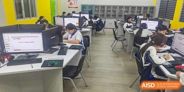 Students at Shenzhen (Nanshan) Concord College of Sino-Canada focused on their work at desks with computers.