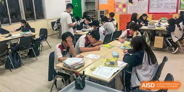 Students at Shenzhen (Nanshan) Concord College of Sino-Canada working on a hands-on project with a teacher in a classroom.