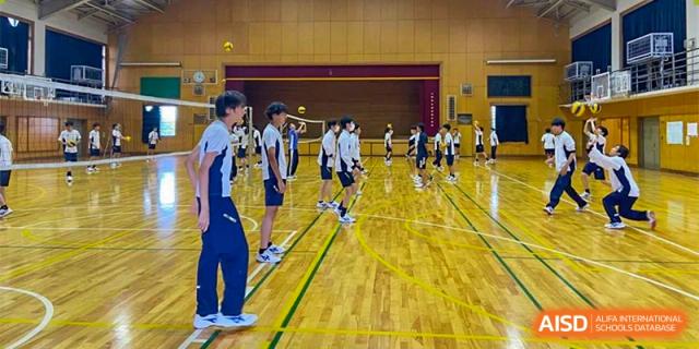 Students at Shenzhen (Nanshan) Concord College of Sino-Canada playing volleyball in a gymnasium.