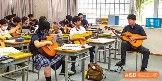 A classroom of students at Shenzhen (Nanshan) Concord College of Sino-Canada learning to play acoustic guitars.