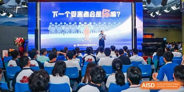 A teacher at Shenzhen (Nanshan) Concord College of Sino-Canada speaking to a class from the stage.