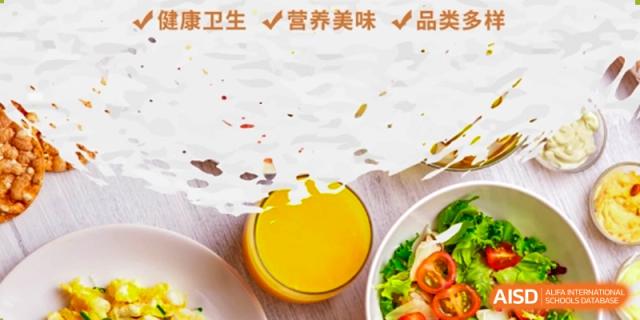 A close-up of a fruit salad and a glass of juice in a canteen at Shenzhen (Nanshan) Concord College of Sino-Canada.