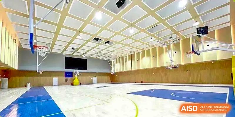 Sias International School indoor basketball court and multipurpose gymnasium with a light-colored wood floor.