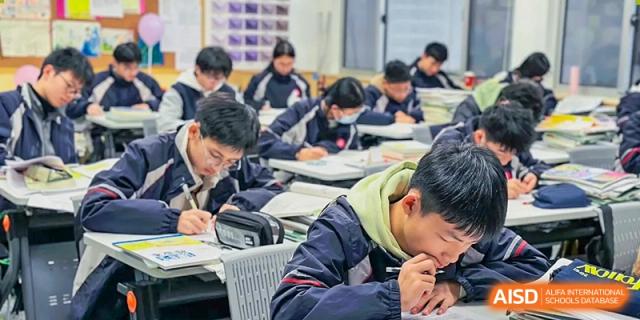 Students are sitting at their desks in a classroom, focused on their work at SUZHOU INTERNATIONAL FOREIGN LANGUAGE SCHOOL.