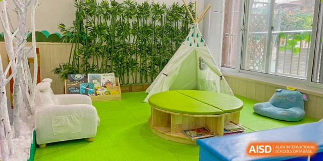 A cozy play area with a teepee tent and a green table at SUZHOU INTERNATIONAL FOREIGN LANGUAGE SCHOOL.