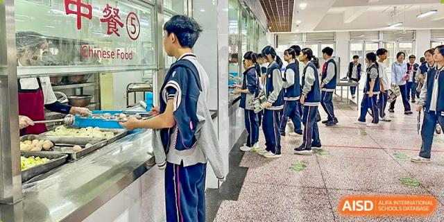 Students standing in a line in the cafeteria at SUZHOU INTERNATIONAL FOREIGN LANGUAGE SCHOOL.