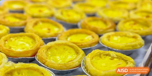 A close-up shot of yellow egg tarts at SUZHOU INTERNATIONAL FOREIGN LANGUAGE SCHOOL.