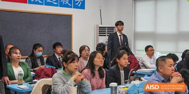 A group of students at The Experimental School Affiliated to Nanjing Normal University listening attentively.