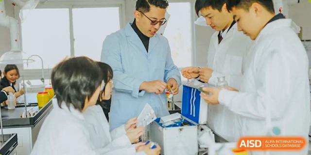 A teacher helping students at The Experimental School Affiliated to Nanjing Normal University with a science experiment.
