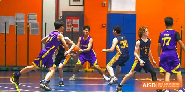 Students from The Experimental School Affiliated to Nanjing Normal University are playing basketball in a gym.