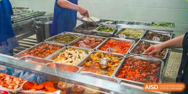 A close-up of a cafeteria buffet line at The Experimental School Affiliated to Nanjing Normal University.