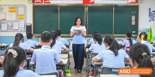 A teacher lecturing students in a classroom at Weiming School Chengdu Qingbaijiang.