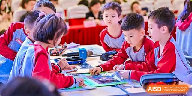Young students of Weiming School Chengdu Qingbaijiang working at their desks.