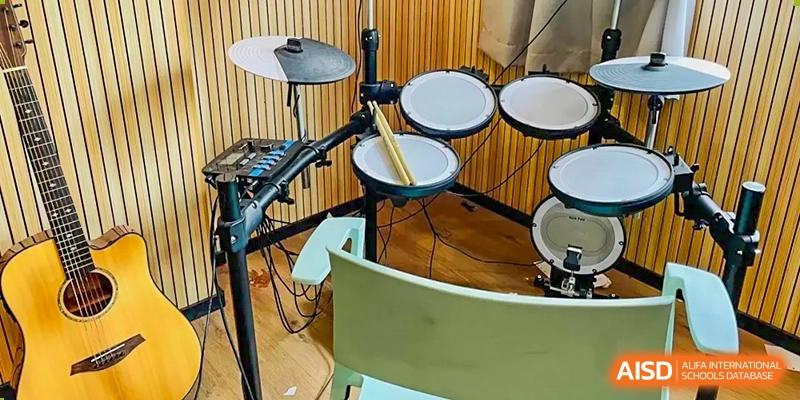 A close-up of an electronic drum set in a music room or practice space at Weiming School Shenzhen Nanshan.