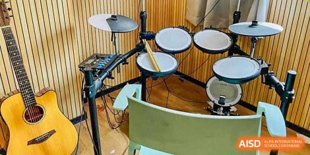 A close-up of an electronic drum set in a music room or practice space at Weiming School Shenzhen Nanshan.