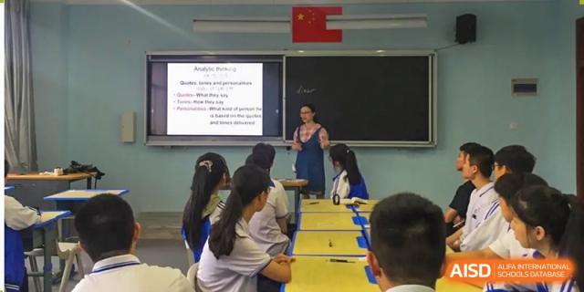 Teacher instructs students near a whiteboard with text in a science classroom at Wenzhou No.21 Middle School.