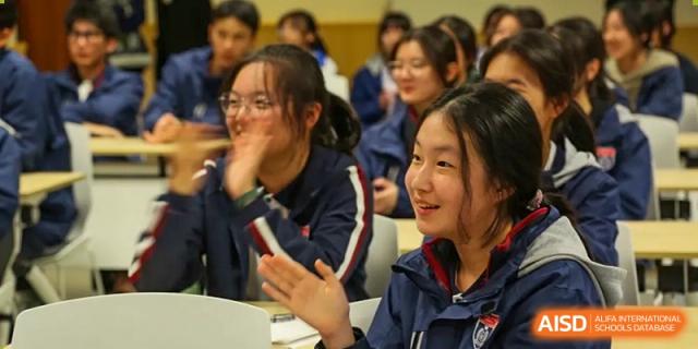 Female students smiling, clapping, and participating actively during class at Wenzhou No.21 Middle School.