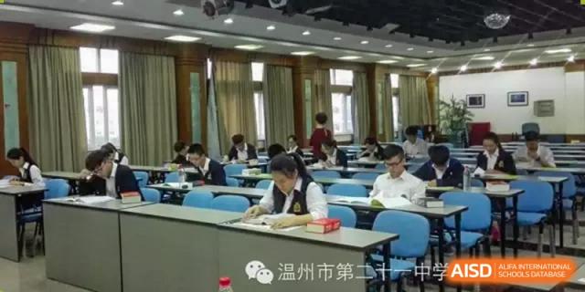 Students working at desks in a large, well-lit classroom, confirmed to be Wenzhou No.21 Middle School.