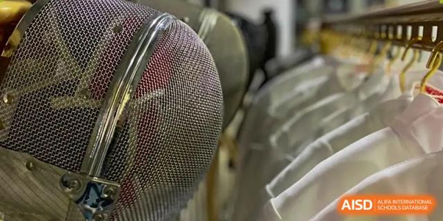 Close-up of a metallic mesh fencing mask, representing the sport or equipment used at Wenzhou No.21 Middle School.