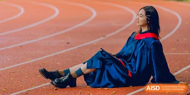 Student resting on a running track, symbolizing athletics at Wenzhou No.21 Middle School.