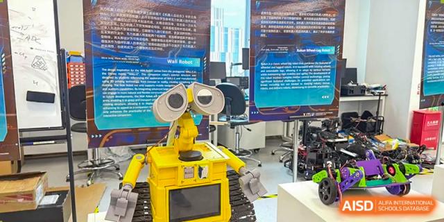 A yellow, Wall-E style robot on display, representing technology and robotics programs at Wuhan Optics Valley ULINK School.