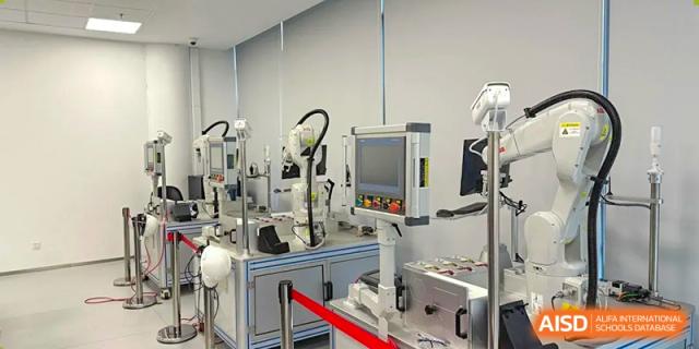 Modern industrial robotics equipment on display in an engineering or technology lab at Wuhan Optics Valley ULINK School.