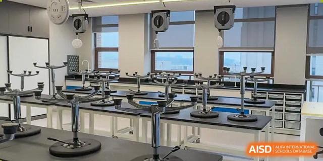 A clean, organized science laboratory with multiple black workstations and white counter tops at Wuhan Optics Valley ULINK School.