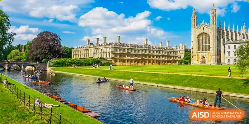 A picturesque scene showing the historic buildings of Cambridge University, with people punting on the River Cam, illustrating a common destination for graduates of Wuhan Optics Valley ULINK School.