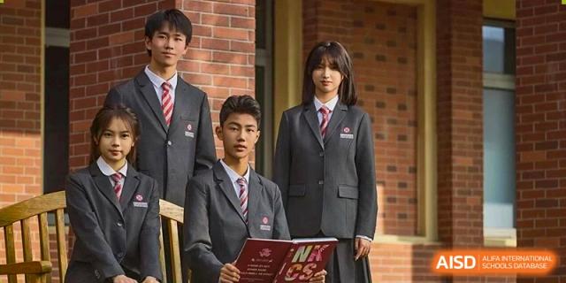 A group of high school students in formal school uniform standing and looking at the camera outdoors at Wuxi Dipont School of Arts and Science.