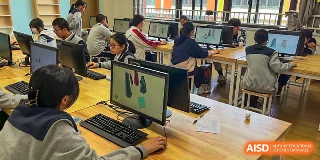 Students working on computer-aided design (CAD) or graphic software in a computer lab at Wuxi Kuangyuan Bilingual School.
