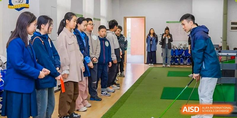 A line of students walking or standing in a hallway or large indoor space during a school activity at Wuxi Kuangyuan Bilingual School.