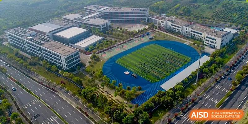 Aerial view of the sports field and running track during an event at Wuxi United International School.