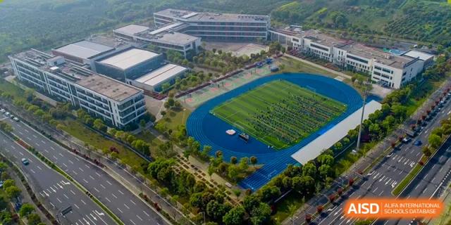 Aerial view of the sports field and running track during an event at Wuxi United International School.