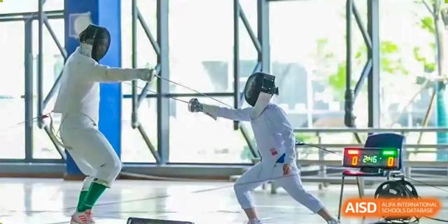Student fencer in full gear practicing or competing in a lunge position at Wuxi United International School.