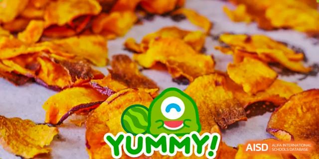 A close-up food image with a "YUMMY!" cartoon graphic overlay, showing baked orange slices or chips. This is food from Wuxi United International School.
