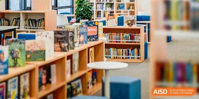 A library at Wycombe Abbey School Nanjing with colorful books on shelves.