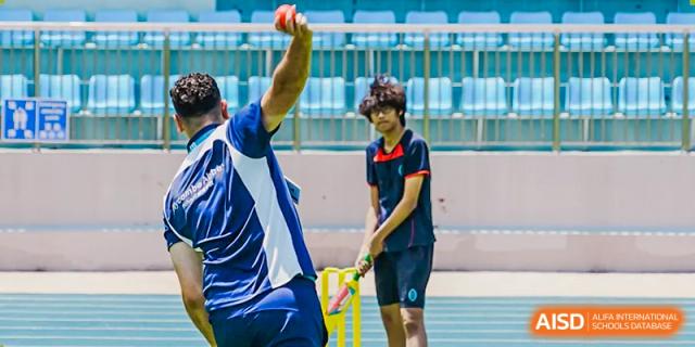 Two students from Wycombe Abbey School Nanjing playing cricket.