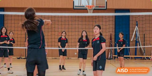 Students from Wycombe Abbey School Nanjing playing volleyball on a court.