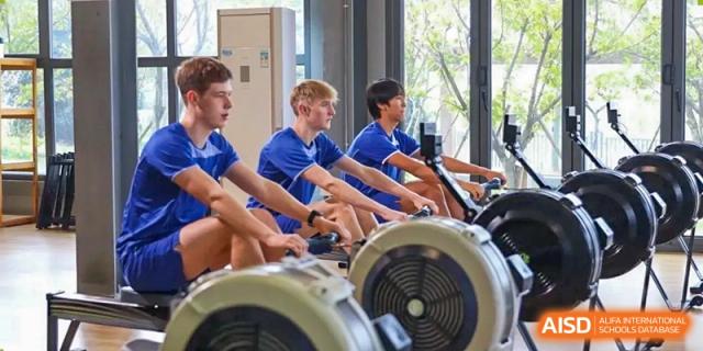 Two students from Wycombe Abbey School Nanjing doing indoor rowing exercises.