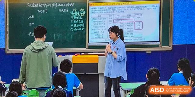 A teacher from Xiamen Yingcai school giving a lecture to students in a classroom.