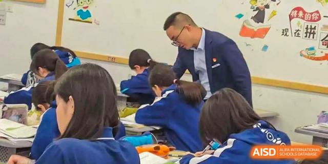 Students from Xiamen Yingcai school taking an exam in a classroom.