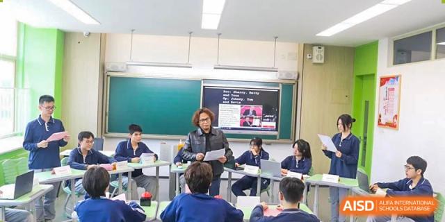 Students from Xiamen Yingcai school participating in a class discussion with a teacher.