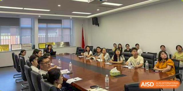 Teachers and parents from Xiamen Yingcai school attending a meeting in a conference room.