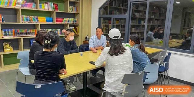 Teachers from Xiamen Yingcai school meeting in the school library.
